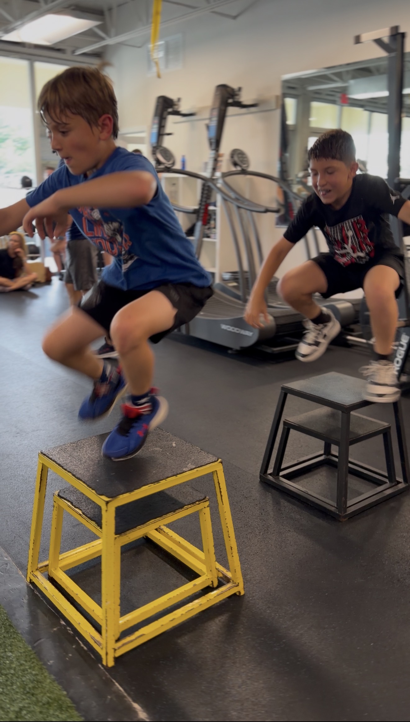 Two kids jumping on plyo boxes during Boca Youth Fit at Gravity and Oxygen